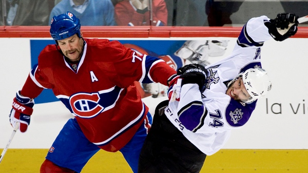 Montreal Canadiens' Hal Gill, left, checks Los Angeles Kings' Dwight King during second period NHL hockey action in Montreal, Wednesday, November 24, 2010.THE CANADIAN PRESS/Graham Hughes