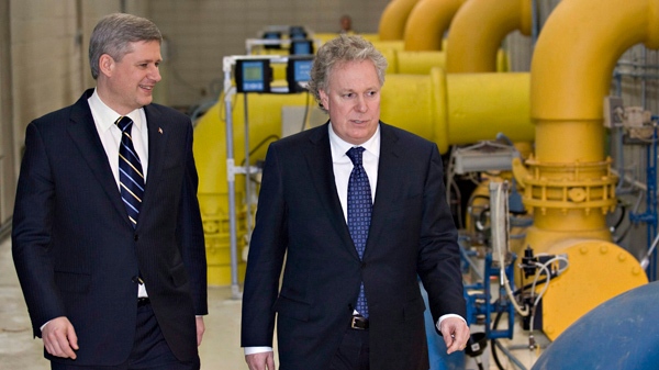 Prime Minister Stephen Harper, left, and Quebec Premier Jean Charest, seen here in 2009, are reportedly close to an agreement to compensate the province for harmonizing its sales tax a decade ago. THE CANADIAN PRESS/Jacques Boissinot