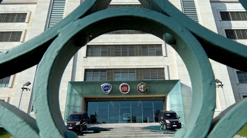 This Jan. 27, 2010 file photo shows the Fiat, Lancia and Alfa Romeo logos on the exterior of the Mirafiori Plant in Turin, northern Italy. (AP Photo/Massimo Pinca, file)