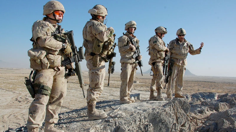Canadian troops stand atop an observation post in Folad, Afghanistan, Nov. 23, 2010. (Murray Brewster / THE CANADIAN PRESS)
