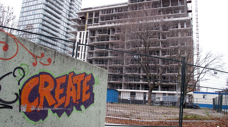 Graffiti in Regent Park serves to illustrate the backdrop, the contruction of one of the new high-rise buildings, part of the Regent Park revitalization project.