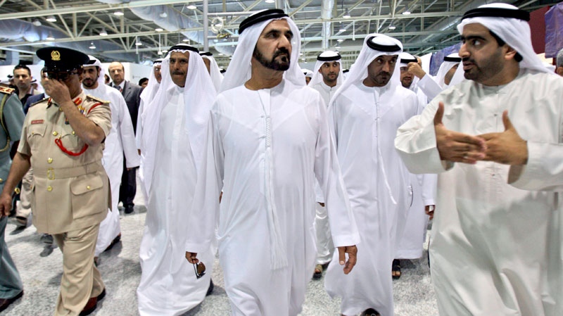 Sheik Mohammed bin Rashid al-Maktoum Prime Minister of UAE and ruler of Dubai, center, listens to an Emirati employee as he visits Al Maktoum International Airport, in Dubai, United Arab Emirates, Thursday, July 1, 2010. (AP / Kamran Jebreili)