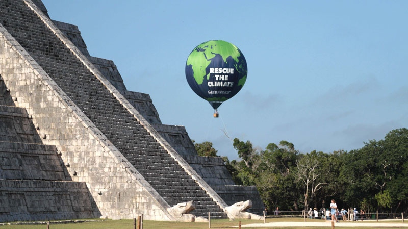 An aerostatics balloon of the environmental group Greenpeace is seen next to the Mayan ruins of Chichen Itza in Mexico, Sunday, Nov. 28, 2010. (AP Photo/Israel Leal)