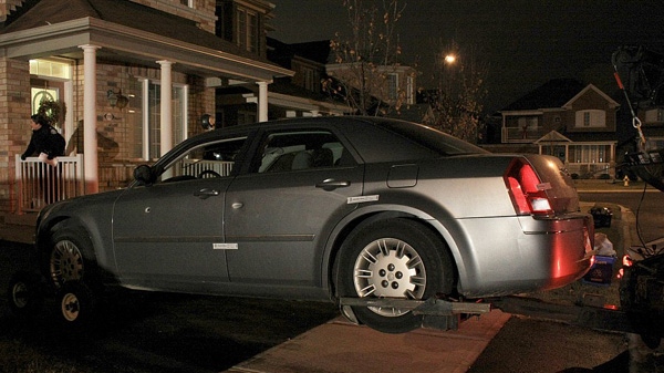 Police remove the Chrysler 300 vehicle from a residence in Vaughan. (Tom Stefanac/CTV News)