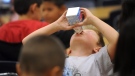 A Grade 2 student in Abilene, Texas, drinks his milk during lunch in this 2011 file photo. (AP Photo/Abilene Reporter-News/Nellie Doneva)