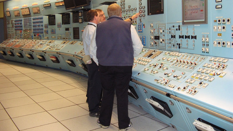 Workers from NB Power examine gauges in a control room simulator at the Point Lepreau nuclear power station on Monday Nov. 29, 2010, in Lepreau, N.B. (THE CANADIAN PRESS/ Kevin Bissett)