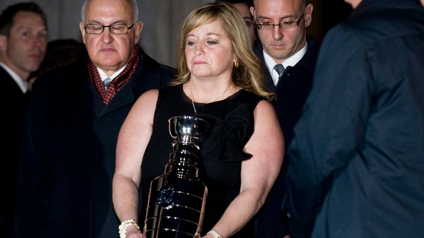 Line Burns carries an urn containing the remains of her late husband, former Montreal Canadiens coach Pat Burns. THE CANADIAN PRESS/Graham Hughes