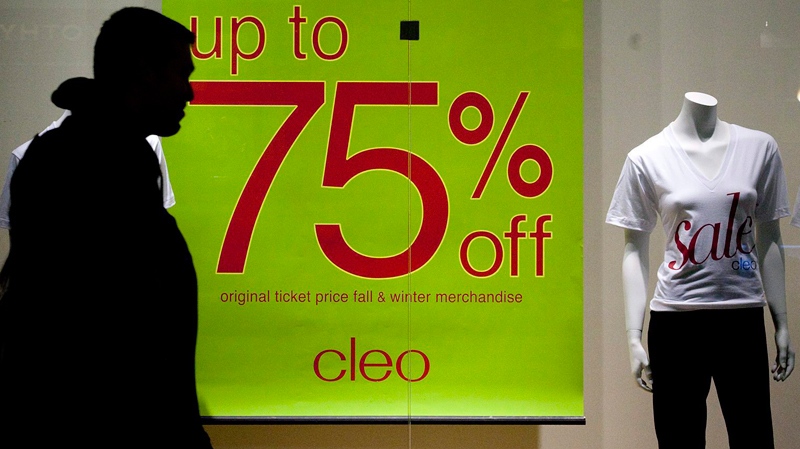 A shopper walks past a sign at Bayshore Shopping Centre in Ottawa. (Pawel Dwulit / THE CANADIAN PRESS) 