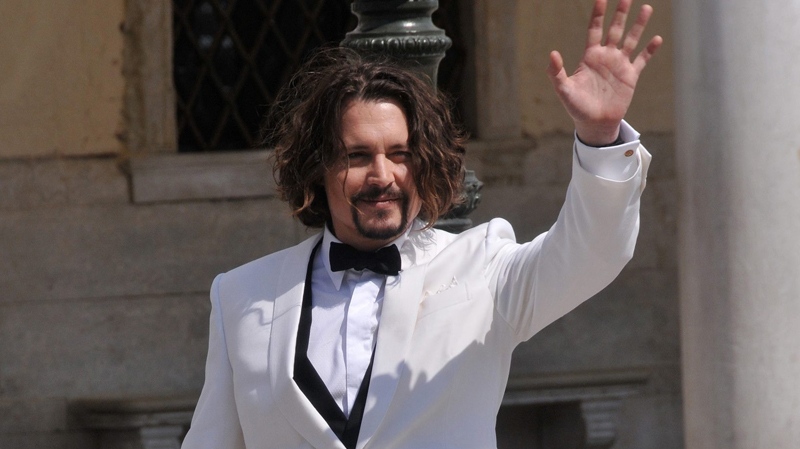 Johnny Depp waves to fans during a break in the shooting of the movie 'The Tourist,' directed by German director Florian Henckel von Donnersmarck, in Venice, Italy, Thursday, May 13, 2010. (AP / Luigi Costantini)