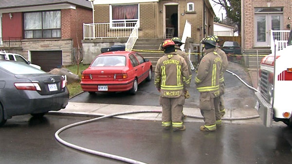 Firefighters gather outside 101 Robinson Ave. on Wednesday, Dec. 1, 2010. One person died in the blaze.