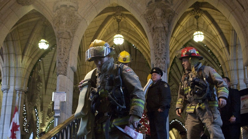Ottawa firefighters leave the rotunda on Parliament Hill after a fire alarm went off during Question Period in Ottawa on Tuesday, November 30, 2010. (THE CANADIAN PRESS/Pawel Dwulit)