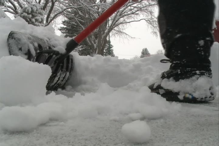 A woman has been charged after allegedly hitting someone with a snow shovel.