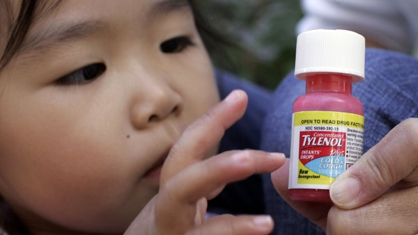 Carleen Ho holds a bottle of Concentrated Tylenol Infants' Drops Plus Cold & Cough in front of her daughter, Rachel Ho, who is under two years old, at a home in Palo Alto, Calif., Thursday, Oct. 11, 2007. (AP Photo/Paul Sakuma)
