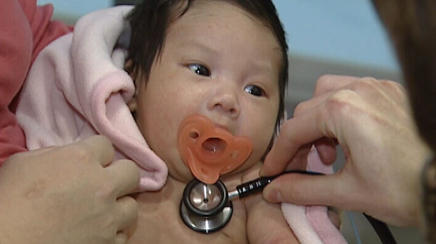 CHEO Emergency Physician checks infant for fever