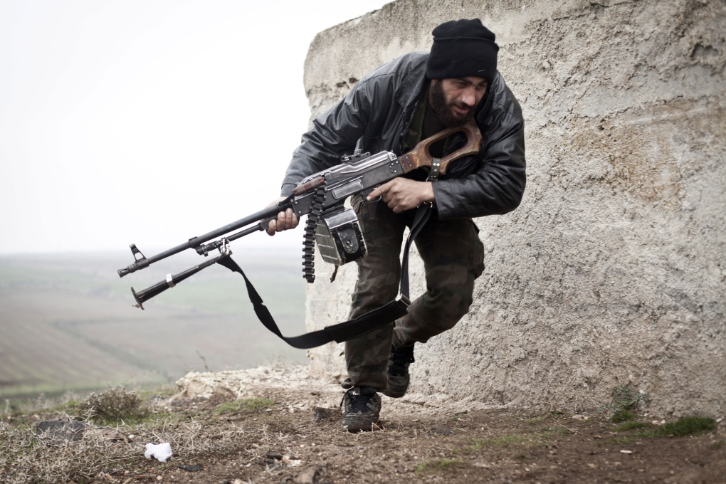 Free Syrian Army fighter takes cover