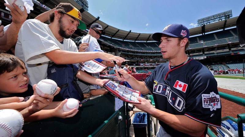 Brett Lawrie of Canada, playing for the World Team, signs autographs prior to the 2010 All-Star Futures game against the U.S. Team, Sunday, July 11, 2010, in Anaheim, Calif. (AP / Mark J. Terrill)