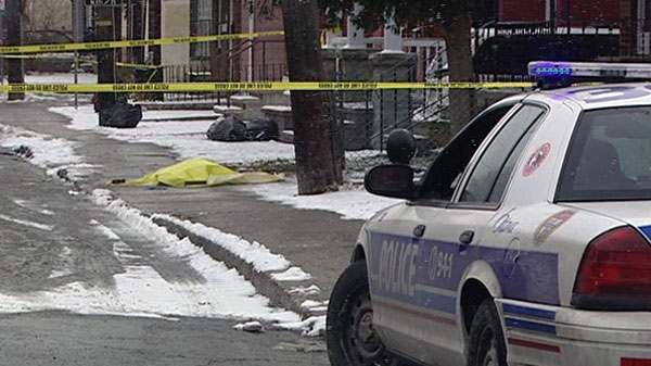 A yellow tarp covers evidence after a shooting victim was dumped on Booth Street in Ottawa, Monday, Dec. 6, 2010.