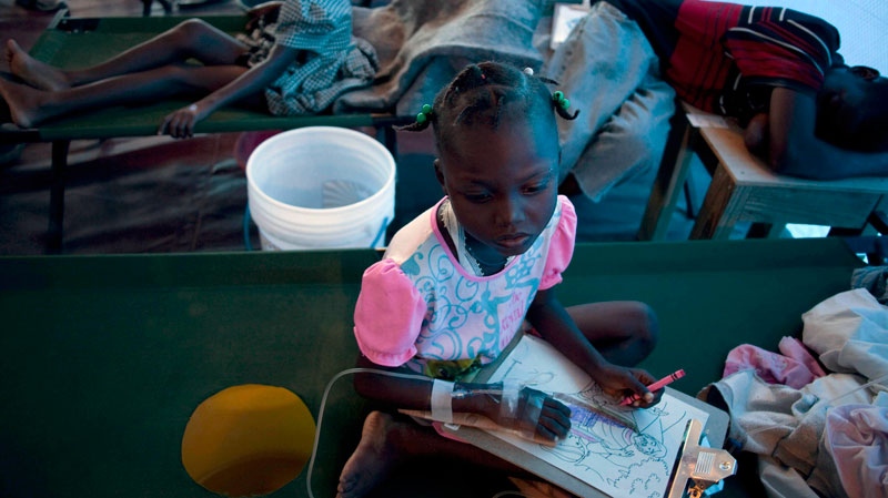 Lovencia Saint Pier, a girl suffering cholera symptoms, draws as she is treated at a clinic in Port Au Prince, Haiti, Tuesday, Dec. 7, 2010. (AP / Guillermo Arias)