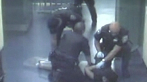 A judge ruled last month that Stacy Bonds, shown on the ground, was treated unlawfully by Ottawa police officers in September 2008.