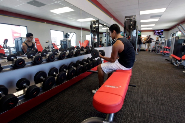 A customer works out at a Snap Fitness in this June 2012 file photo. (AP Photo/LM Otero)