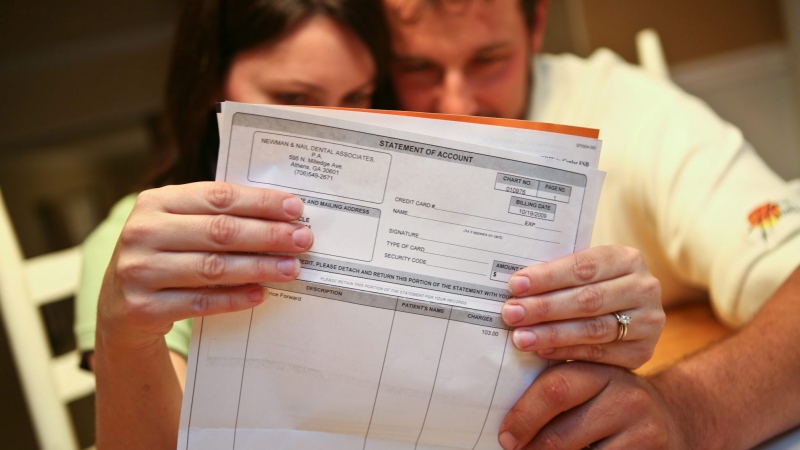 A couple sits down to look over their monthly bills in this 2009 file photo. (AP / Jenni Girtman)