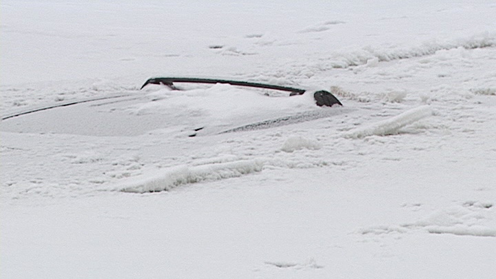 A vehicle that plunged through the ice of McLaurin Bay, Wednesay evening, could be stuck there until the spring.