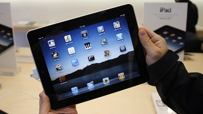 A customer uses an Apple iPad on the first day of Apple iPad sales at an Apple store in San Francisco, April 3, 2010. (AP / Paul Sakuma)