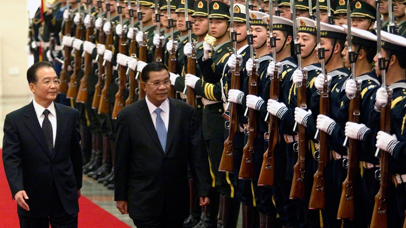 Cambodia's Prime Minister Hun Sen, front right, walks along with Chinese Primier Wen Jiabao, front left, while reviewing the honour guard during a welcome ceremony at the Great Hall of the People in Beijing, Monday, Dec. 13, 2010. (AP / Alexander F. Yuan)