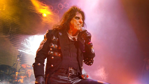 U.S musician Alice Cooper, left, is photographed as he performs his 'Halloween Night of Fear' show at The Roundhouse in north London, Sunday, Oct. 31, 2010. (AP / Joel Ryan)