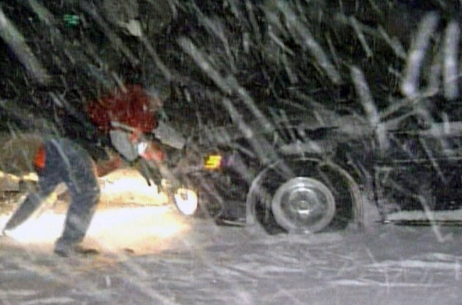 Motorists attempt to free their cars from snow banks on Highway 402, near Sarnia, Ont., early Tuesday, Dec. 14, 2010.   