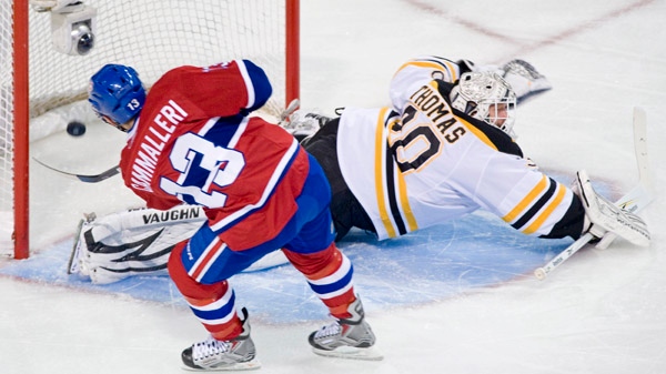 Montreal Canadiens' Michael Cammalleri, left, scores a penalty shot on Boston Bruins' goaltender Tim Thomas during first period NHL action in Montreal Thursday, December 16, 2010.THE CANADIAN PRESS/Graham Hughes