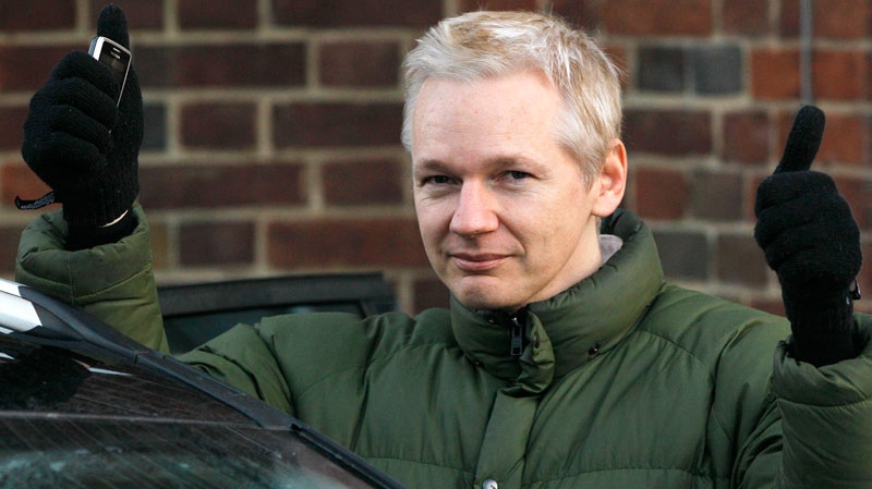 Julian Assange, head of WikiLeaks, gestures as he gets back into a car at Beccles Police Station in Suffolk, England, Friday, Dec. 17, 2010. (AP / Kirsty Wigglesworth)