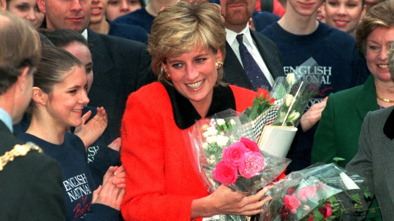 This is a Wednesday Dec. 6, 1995 photo of the Princess of Wales as she smiles after receiving bouquets of flowers from admirers as she leaves the English National Ballet school opening in London. (AP / Jacqueline Arzt)