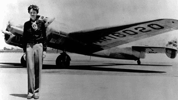 Amelia Earhart stands next to a Lockheed Electra 10E in Oakland, Calif., before the first leg of her attempt to fly around the world along the Equator, in this undated file photo. (AP Photo)