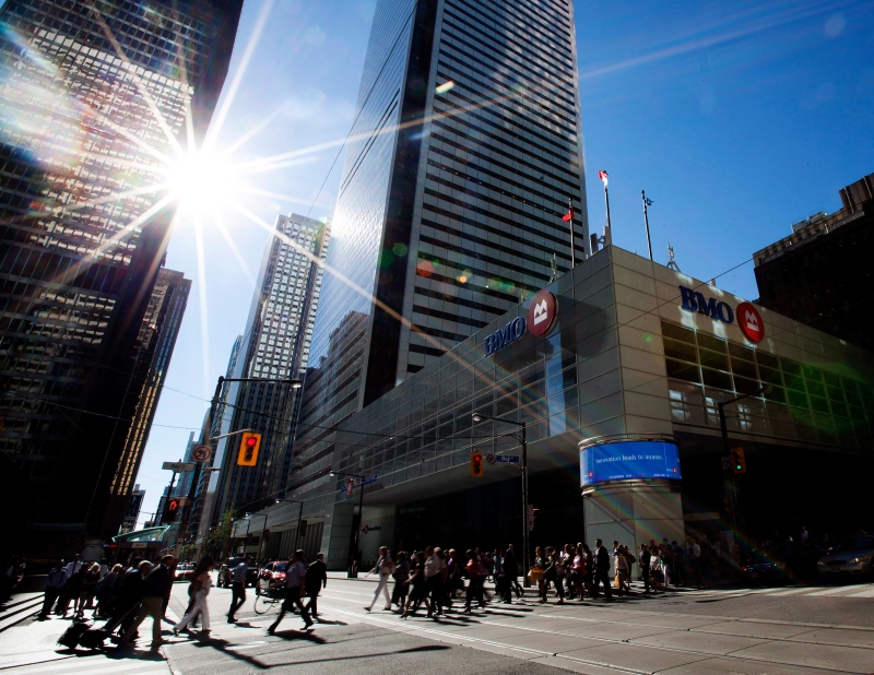 People pass by the Bank of Montreal in Toronto on Tuesday, August 28, 2012. (THE CANADIAN PRESS/Michelle Siu)