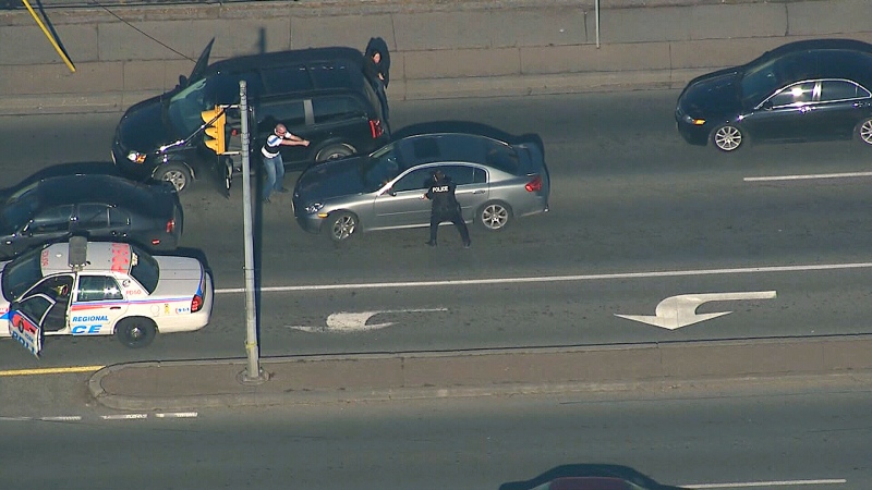 Police take aim at the driver of a car during an arrest near Sheridan Mall in North York on Wednesday, Jan. 16, 2013.
