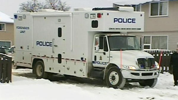 Police officials arrive at the scene where two children were found dead at a home in Edmonton on Monday, Dec. 20, 2010.