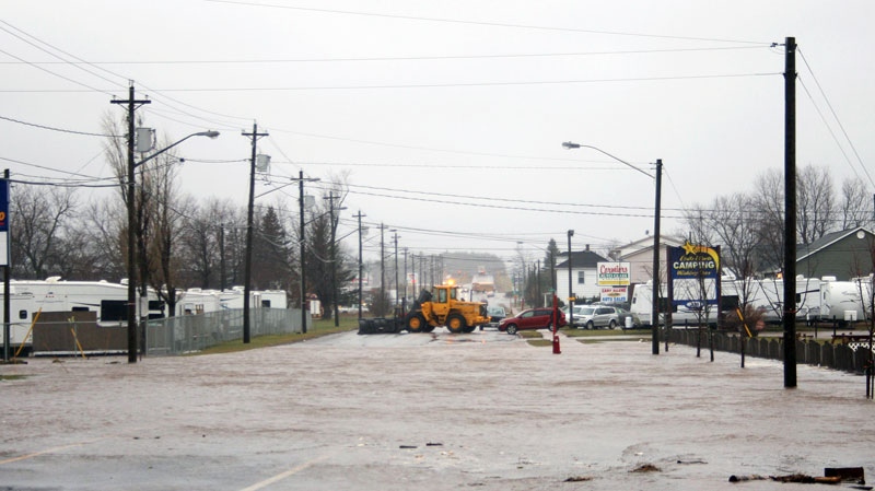 High water reaches Main St. as a plow blocks traffic in Shediac N.B. on Tuesday Dec. 21, 2010. (Peter Langis / THE CANADIAN PRESS)