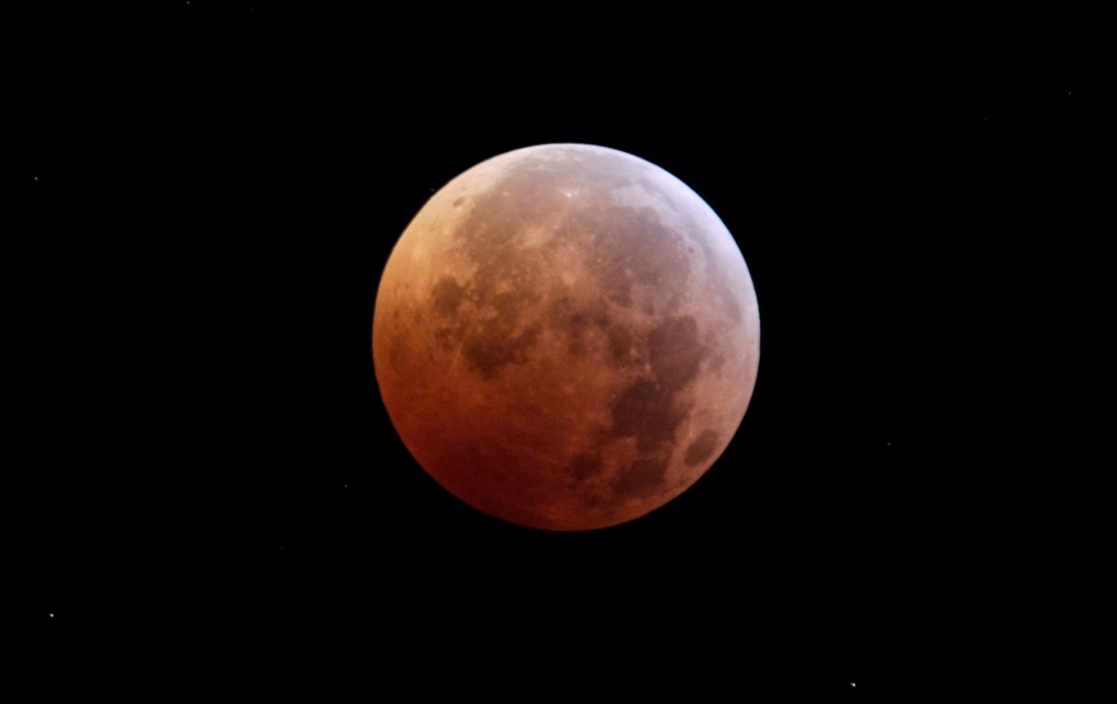 The moon is seen during a total lunar eclipse from New York, Tuesday, Dec. 21, 2010. A total lunar eclipse occurs when the Earth casts its shadow on the full moon, blocking the sun's rays that otherwise reflect off the moon's surface. Some indirect sunlight still pierces through to give the moon its red hue. (AP Photo/Seth Wenig)
