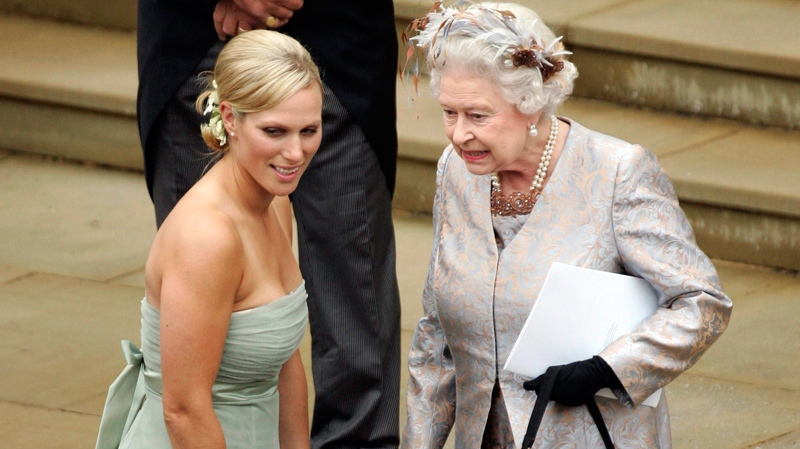 The Queen talks to her granddaughter Zara Phillips as they watch Peter Phillips and Canadian Autumn Kelly leave St. George's Chapel in Windsor, England, after their marriage ceremony, Saturday, May 17, 2008. (AP / Sang Tan)