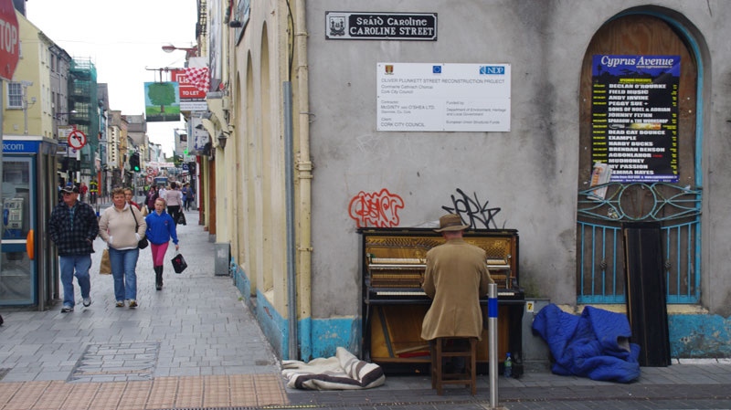 A man plays a piano in a pedestrian and shopping area in the Irish city of Cork on Sept. 18, 2010. (Geoff Nixon / CTV.ca)