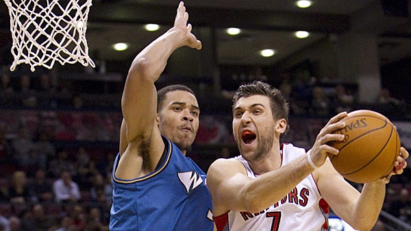 Toronto Raptors' Andrea Bargnani, right, screams while driving into Washington Wizards' defender JaVale McGee during first-half NBA basketball action in Toronto on Wednesday, Dec. 1, 2010. (THE CANADIAN PRESS/Darren Calabrese)