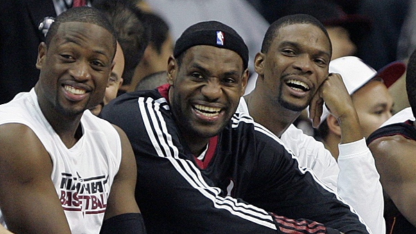 From left to right, Miami Heat's Dwyane Wade, LeBron James, and Chris Bosh laugh in the final moments of their game against the New Jersey Nets in an NBA basketball game at the Prudential Center in Newark, N.J. on Sunday, Oct. 31, 2010. (AP Photo/Rich Schultz)