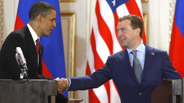 U.S. President Barack Obama, left, and his Russian counterpart Dmitry Medvedev, right, shake hands at a press conference after signing the newly completed "New START" treaty reducing long-range nuclear weapons at the Prague Castle in Prague, Czech Republic Thursday, April 8, 2010. (AP Photo/Mikhail Metzel)
