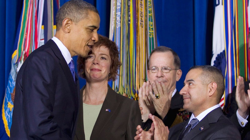 President Barack Obama shakes hands with former Navy Commander Zoe Dunning, as Joint Chiefs Chairman Adm. Mike Mullen, second from right, and former Marine Staff Sgt. Eric Alva applaud during a signing ceremony for  "don't ask, don't tell" repeal legislation that would allow gays to serve openly in the military, Wednesday, Dec. 22, 2010, at the Interior Department in Washington. (AP / Evan Vucci)