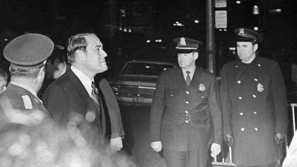 Quebec Justice Minister Jerome Choquette passes Quebec Provincial police security as he enters the courthouse in Montrael, Oct 18, 1970, to pay his respects to fellow cabinet minister Pierre Laporte. THE CANADIAN PRESS/ Stf