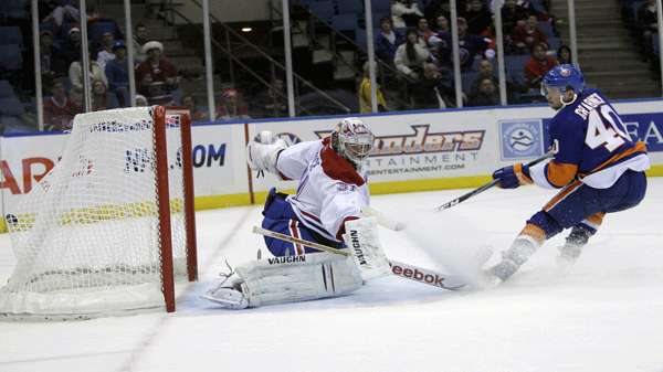 New York Islanders' Michael Grabner, right, scores past Montreal Canadiens goalie Carey Price during the second period of the NHL hockey game Sunday, Dec. 26, 2010, in Uniondale, New York. (AP Photo/Seth Wenig)