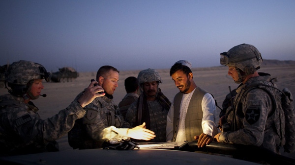 U.S. Lt. Col. William Clark, second from left, talks with Gen. Abdul Razik, the border police commander for southern Afghanistan, during a joint patrol along the border with Pakistan, on the outskirts of Spin Boldak, Afghanistan, Friday, Aug. 7, 2009. (AP Photo/Emilio Morenatti)
