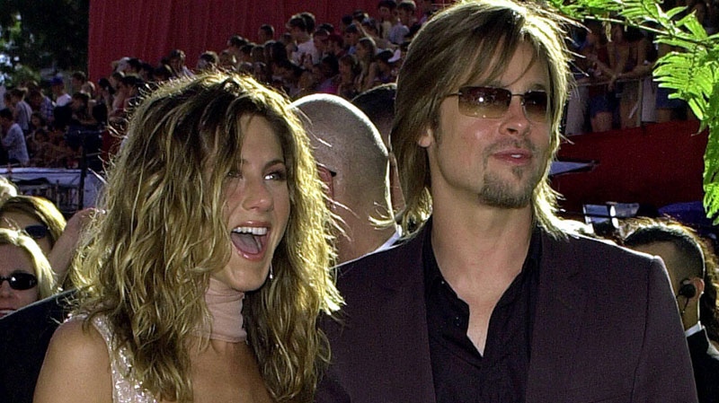 Jennifer Aniston, left, is joined by then-husband Brad Pitt as she arrives at the 54th Annual Primetime Emmy Awards Sunday, Sept. 22, 2002, at the Shrine Auditorium in Los Angeles. (AP Photo/Kim D. Johnson)