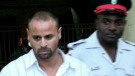 Paul Martin is taken into police custody in Jamaica.